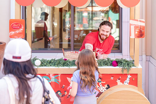 Man handing out Lindt/LINDOR Chocolate